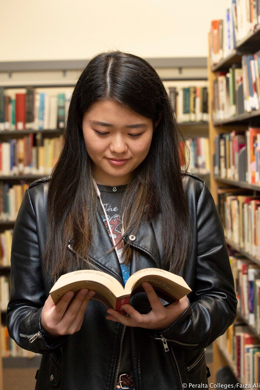 college-student-reading-in-library