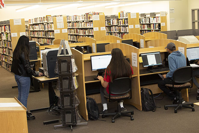 Students at the Library computer kiosks